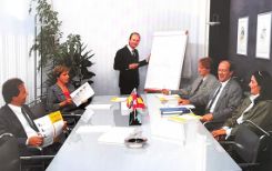 Stefano Rovati (sitting, on the left of the blackboard) during a company meeting in the Nineties